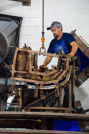 A skilled worker operating a roto molding machine at Beuta headquarters, focused on creating a high-quality product.